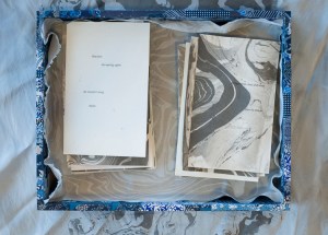 blue collaged box on silk suminagashi, cards inside box with text on another piece of silk